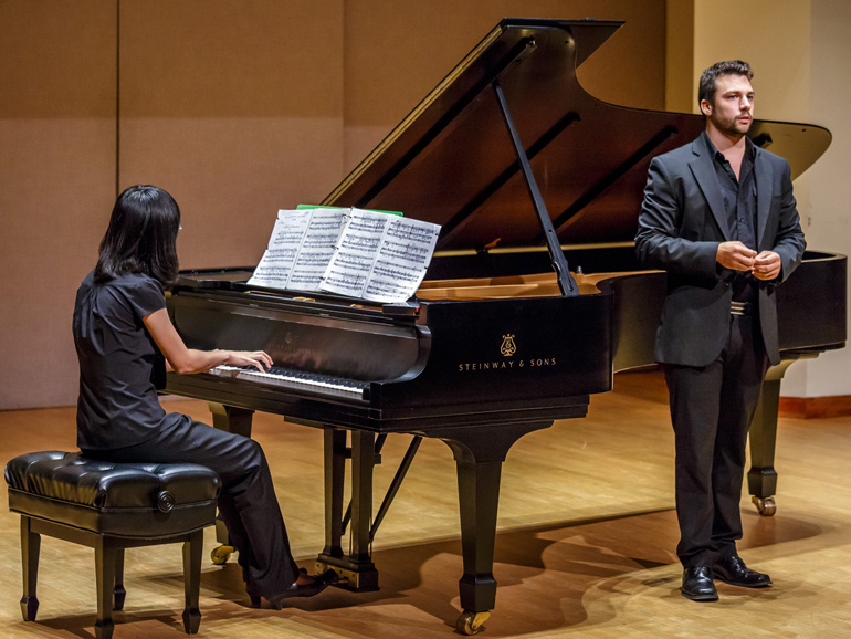 Female Playing Piano While Man Sings