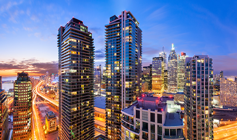 New Condo Building in Downtown Toronto with Skyline at the back